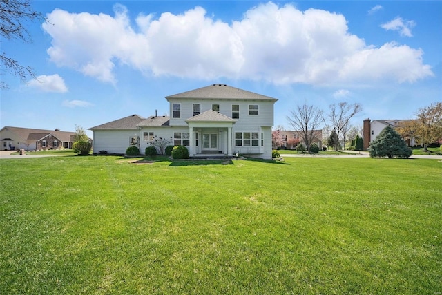 rear view of house with a lawn