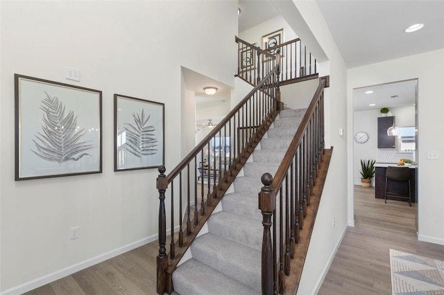 1035 Red Fox Dr, Eureka, MO 63025 - stairs featuring wood finished floors, baseboards, recessed lighting, and ceiling fan