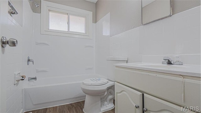 1370 Reale Ave, Saint Louis, MO 63138 - full bathroom featuring vanity, toilet, shower / bathtub combination, and wood finished floors