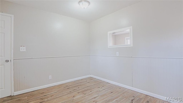 1370 Reale Ave, Saint Louis, MO 63138 - empty room featuring wood finished floors, wainscoting, and baseboards