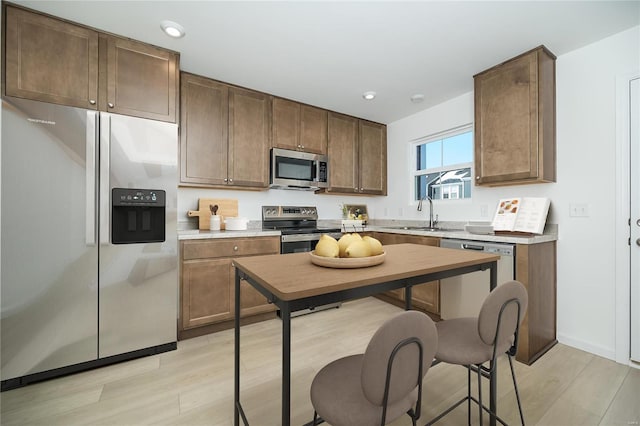 103 Cardow Dr Unit 169-605, Ofallon, MO 63368 - kitchen with appliances with stainless steel finishes, a sink, light wood-style flooring, light countertops, and recessed lighting