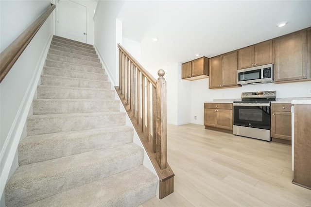 103 Cardow Dr Unit 169-605, Ofallon, MO 63368 - stairway with wood finished floors and recessed lighting