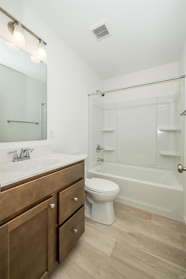 103 Cardow Dr Unit 169-605, Ofallon, MO 63368 - bathroom featuring toilet, wood finished floors, vanity, and shower / washtub combination