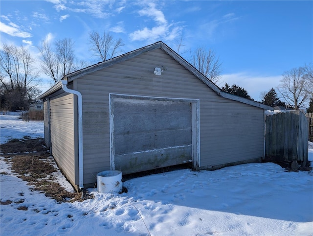 413 N 6th St, New Douglas, IL 62074 - snow covered garage featuring a garage and fence