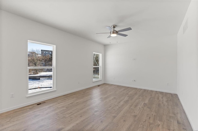 117 Harrow Dr, Ofallon, MO 63385 - spare room featuring plenty of natural light, light wood-type flooring, a ceiling fan, and baseboards