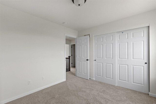 117 Harrow Dr, Ofallon, MO 63385 - unfurnished bedroom featuring light carpet, baseboards, and a closet