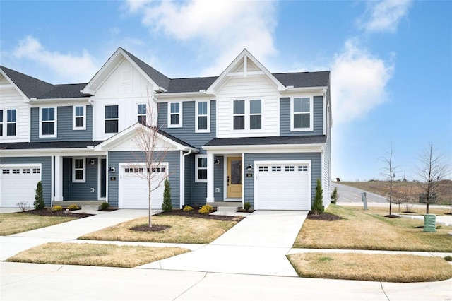 view of front of home with an attached garage, concrete driveway, board and batten siding, and a front yard