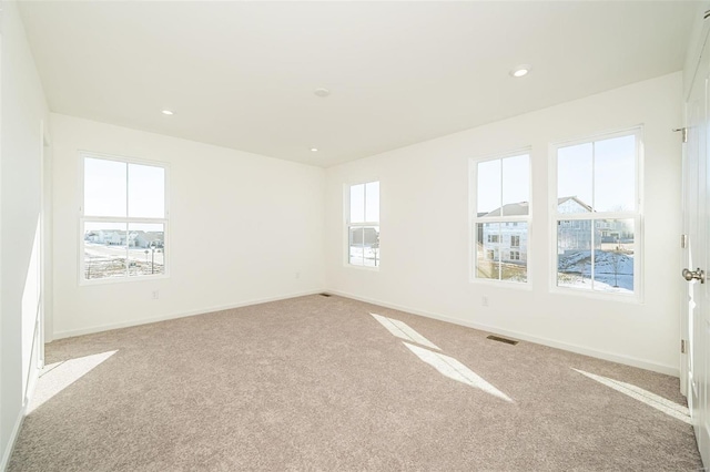 unfurnished room featuring light colored carpet, baseboards, and recessed lighting