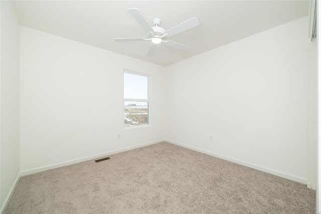 unfurnished room featuring carpet flooring, baseboards, and a ceiling fan
