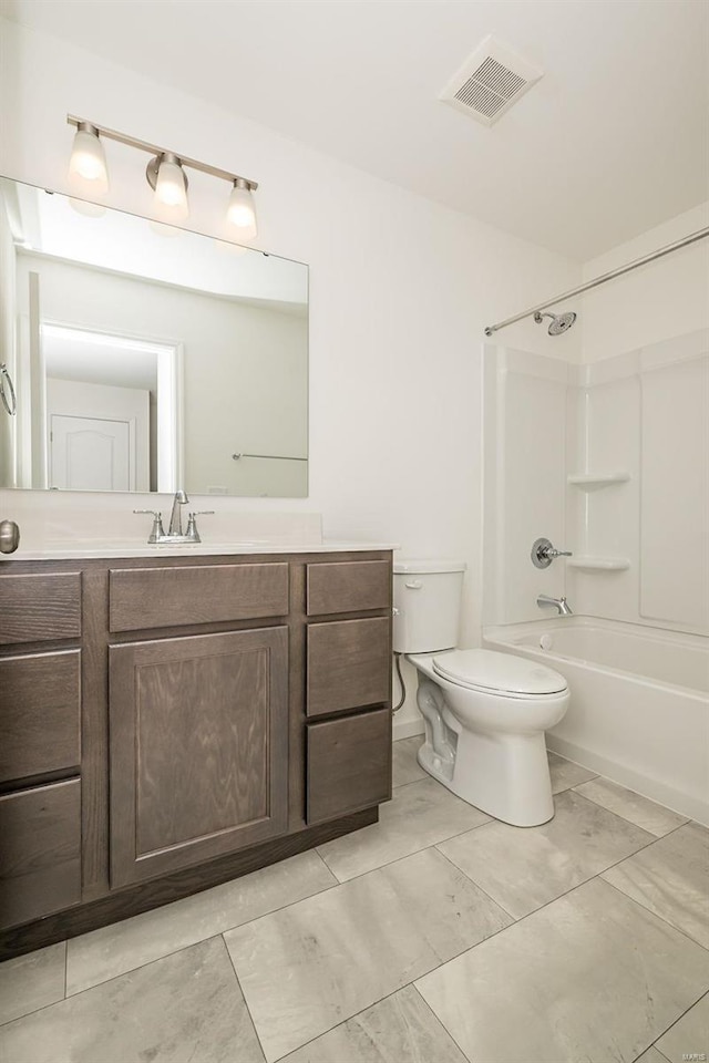 bathroom featuring toilet, vanity, and shower / tub combination