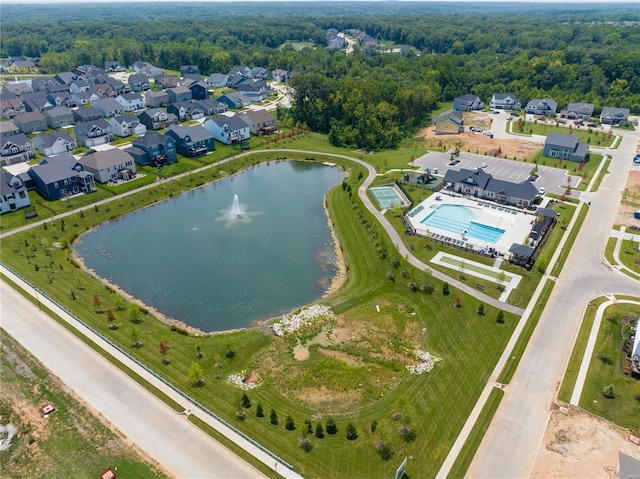 view of property location featuring a nearby body of water, a pool, and nearby suburban area