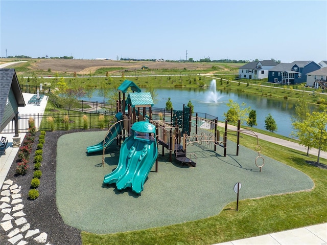 community jungle gym featuring fence and a water view