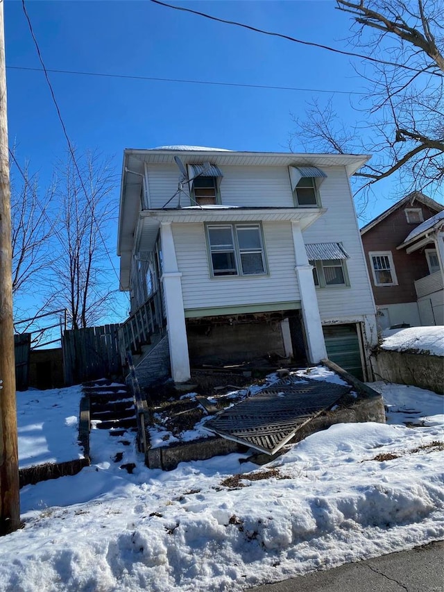 view of front of home with an attached garage and stairs