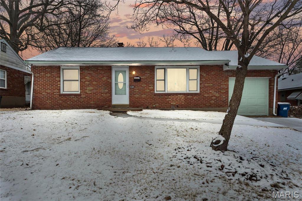 2031 Hildred Ave, Saint Louis, MO 63136 - ranch-style house with brick siding and a garage