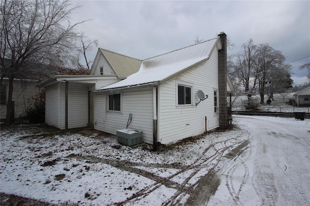 306 S Mine La Motte St, Fredericktown, MO 63645 - snow covered property featuring cooling unit, a chimney, and metal roof