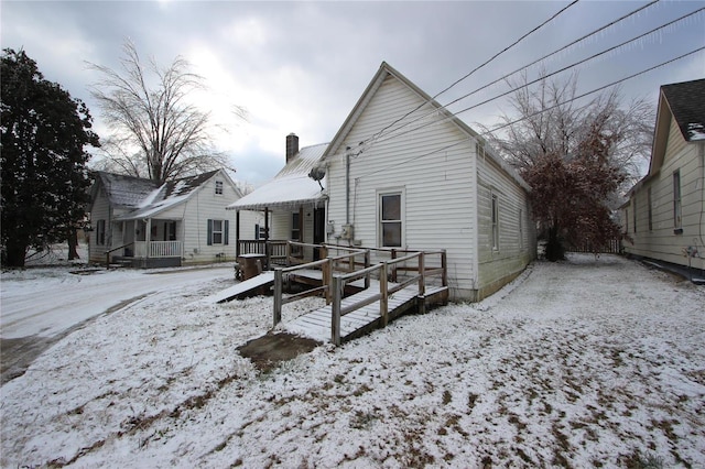 306 S Mine La Motte St, Fredericktown, MO 63645 - snow covered rear of property featuring a chimney