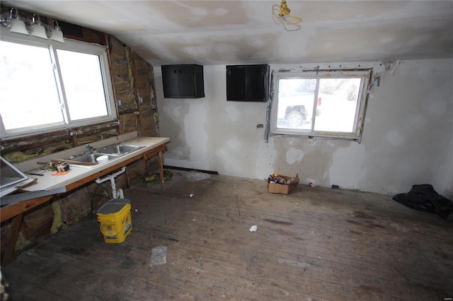 306 S Mine La Motte St, Fredericktown, MO 63645 - kitchen with a sink, vaulted ceiling, wood-type flooring, and dark cabinetry