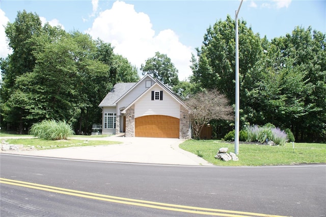 10 Anemone Rd, Lake Ozark, MO 65049 - view of front of home featuring stone siding, concrete driveway, and a front lawn