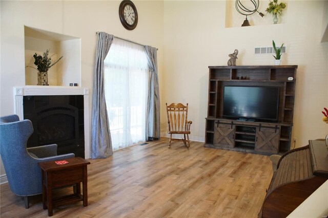 10 Anemone Rd, Lake Ozark, MO 65049 - living room featuring wood finished floors, baseboards, and a fireplace