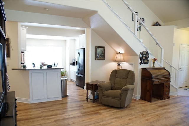 10 Anemone Rd, Lake Ozark, MO 65049 - sitting room with light wood-style floors, stairway, and baseboards