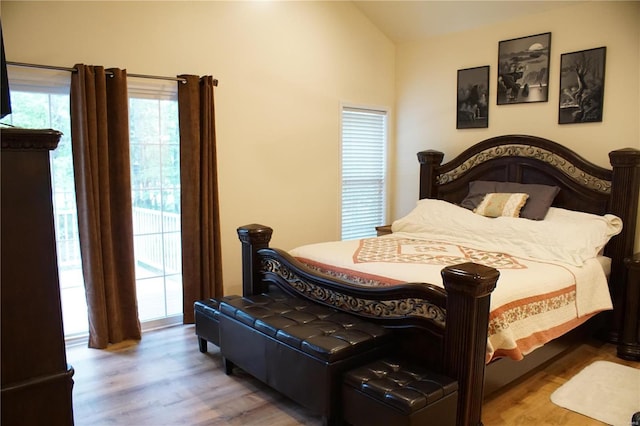 10 Anemone Rd, Lake Ozark, MO 65049 - bedroom with wood finished floors, access to exterior, and vaulted ceiling