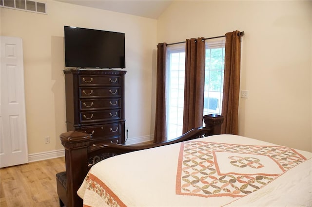 10 Anemone Rd, Lake Ozark, MO 65049 - bedroom featuring light wood finished floors, baseboards, and vaulted ceiling