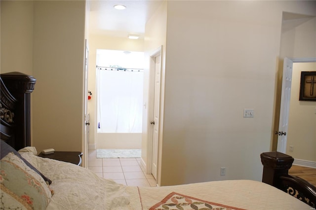 10 Anemone Rd, Lake Ozark, MO 65049 - bedroom featuring light tile patterned floors, ensuite bathroom, and baseboards