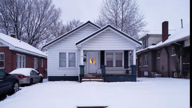 view of front of property featuring covered porch and central AC