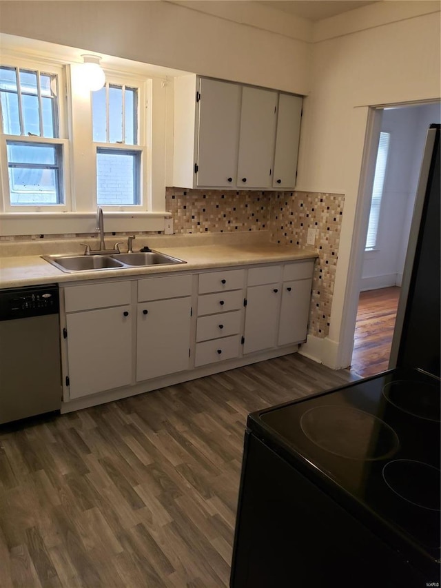 kitchen with stainless steel dishwasher, a sink, black electric range, and wood finished floors