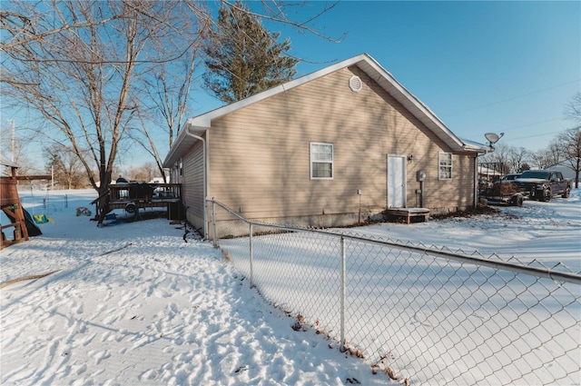 view of snow covered exterior featuring fence