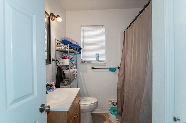 bathroom featuring vanity, toilet, baseboards, curtained shower, and tile patterned flooring