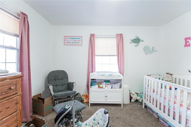 bedroom featuring a crib and carpet