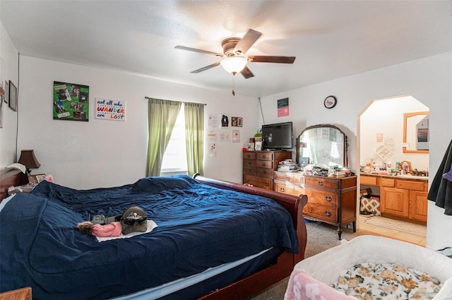 bedroom featuring ensuite bathroom and ceiling fan