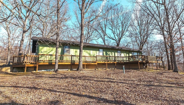 back of house with a deck