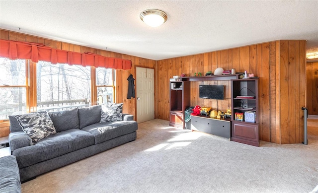 carpeted living area with wooden walls and a textured ceiling
