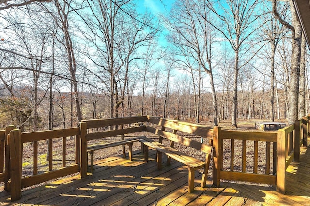 wooden terrace with a view of trees