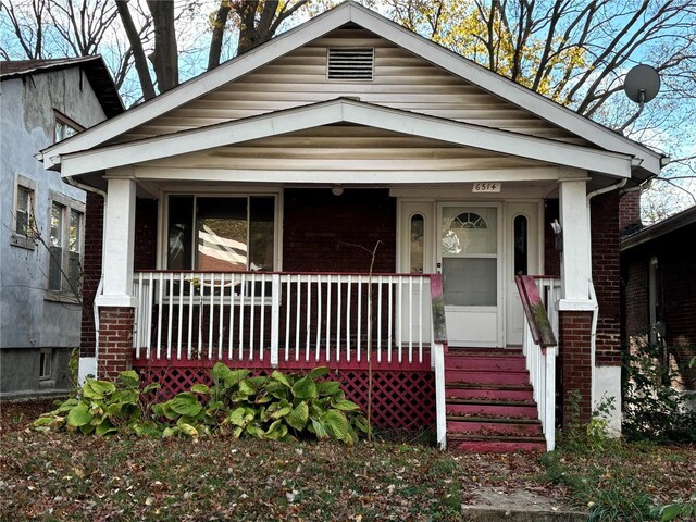 6514 Julian Ave, Saint Louis, MO 63133 - shotgun-style home with a porch and brick siding