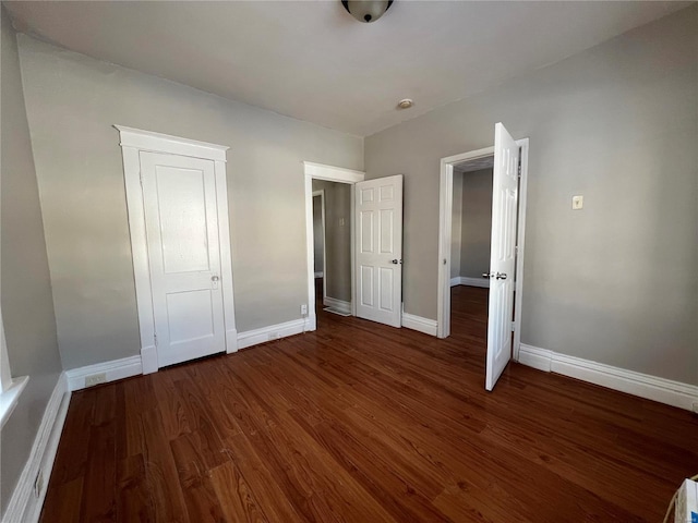 6514 Julian Ave, Saint Louis, MO 63133 - unfurnished bedroom with wood finished floors and baseboards