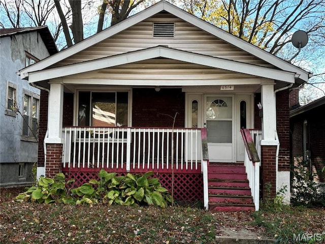 6514 Julian Ave, Saint Louis, MO 63133 - shotgun-style home featuring covered porch and brick siding