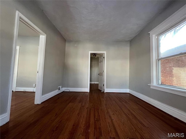 6514 Julian Ave, Saint Louis, MO 63133 - empty room featuring dark wood finished floors and baseboards
