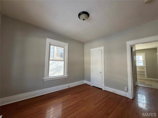 6514 Julian Ave, Saint Louis, MO 63133 - unfurnished bedroom featuring wood finished floors and baseboards