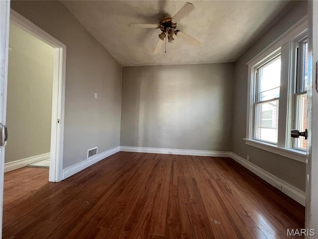 6514 Julian Ave, Saint Louis, MO 63133 - spare room with dark wood-style floors and ceiling fan