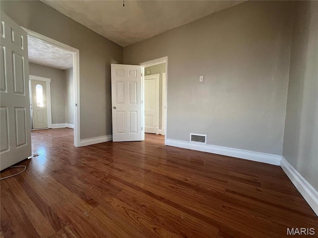 6514 Julian Ave, Saint Louis, MO 63133 - spare room with dark wood-type flooring and baseboards