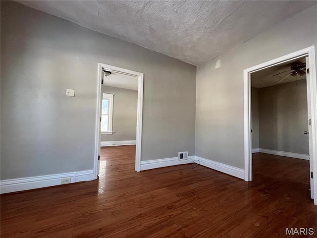 6514 Julian Ave, Saint Louis, MO 63133 - spare room featuring wood finished floors, ceiling fan, and a textured ceiling