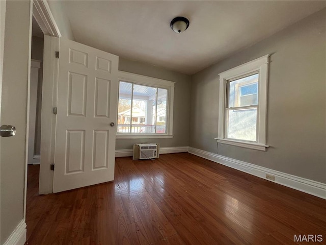6514 Julian Ave, Saint Louis, MO 63133 - unfurnished bedroom featuring dark wood finished floors and a wall unit AC