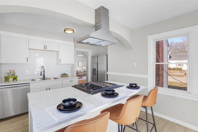 1100 Northdale Ave, Saint Louis, MO 63138 - kitchen featuring stainless steel appliances, a sink, island exhaust hood, and arched walkways