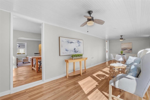 1100 Northdale Ave, Saint Louis, MO 63138 - living area featuring a ceiling fan, arched walkways, light wood-style floors, and baseboards