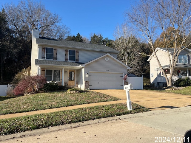 2320 Castlegate Dr, Imperial, MO 63052 - traditional home featuring a chimney, an attached garage, driveway, covered porch, and roof with shingles