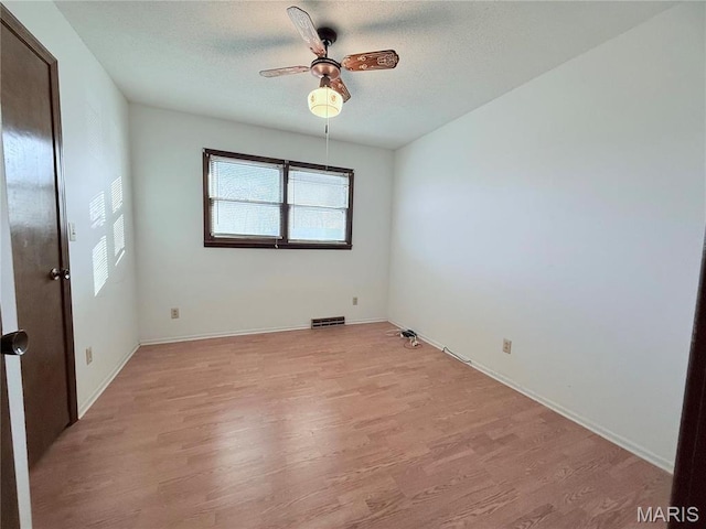 2013 Catalina Dr, West Plains, MO 65775 - spare room featuring light wood-style flooring, ceiling fan, a textured ceiling, and baseboards