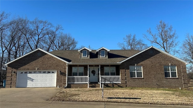 121 Stull Dr, Benton, MO 63736 - view of front facade featuring a porch, brick siding, and an attached garage